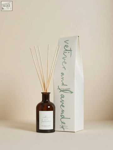 Brown glass vetiver and lavender diffuser with slender wooden sticks and minimalist white label using vegetable oil base