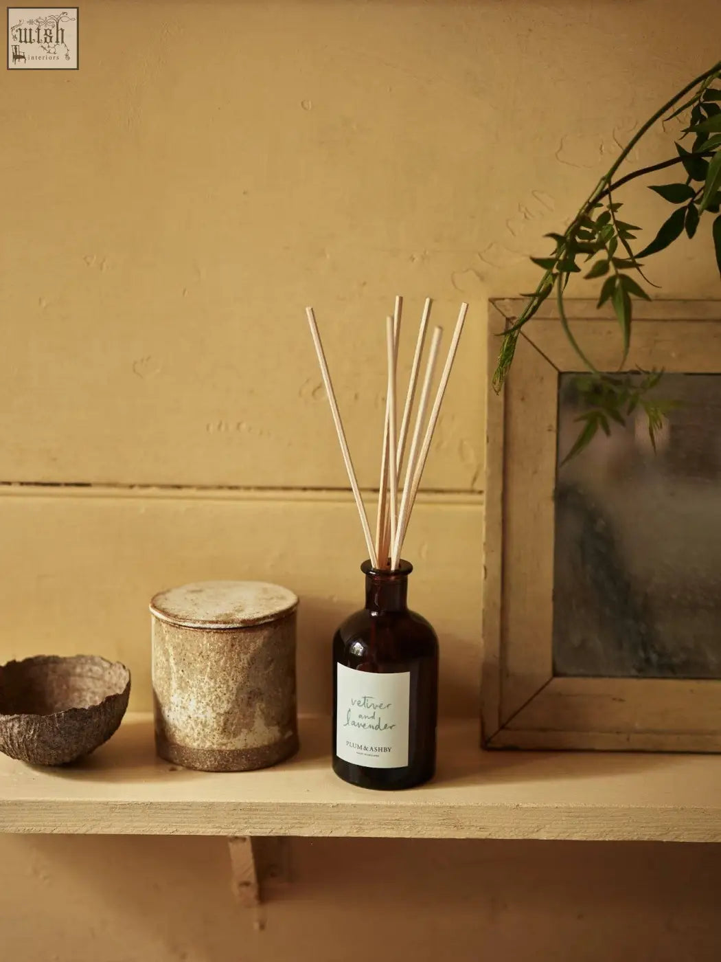 Dark amber glass vetiver and lavender diffuser by vilma & sabro with light wooden reeds and vegetable oil base