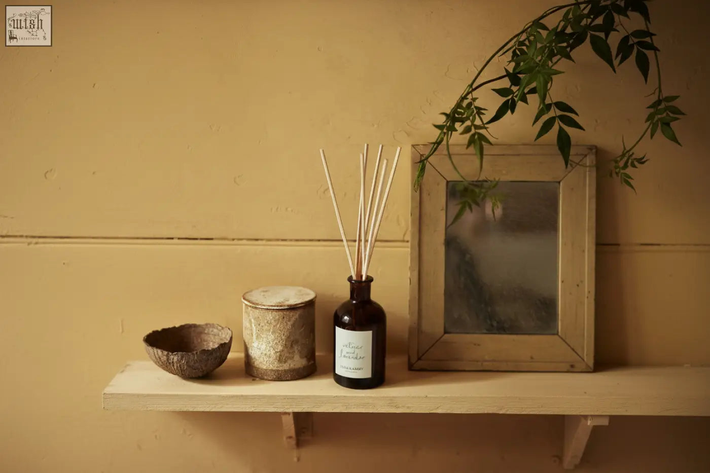 Dark amber glass vetiver and lavender diffuser by vilma and sabro with light wooden reeds and vegetable oil base oil