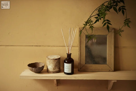 Dark amber glass vetiver and lavender diffuser by vilma and sabro with light wooden reeds and vegetable oil base oil