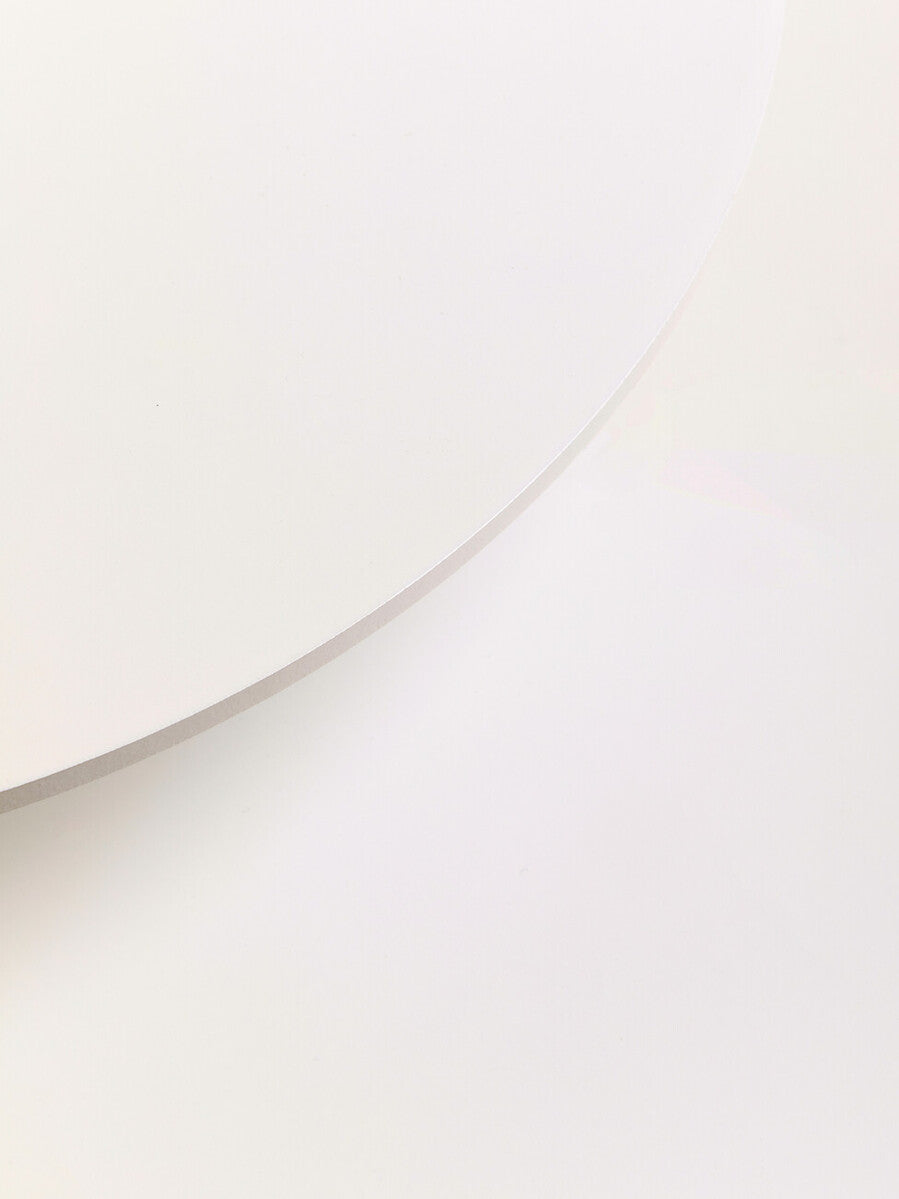 A minimalist two white round side table with a smooth matte finish perfect for modern living spaces