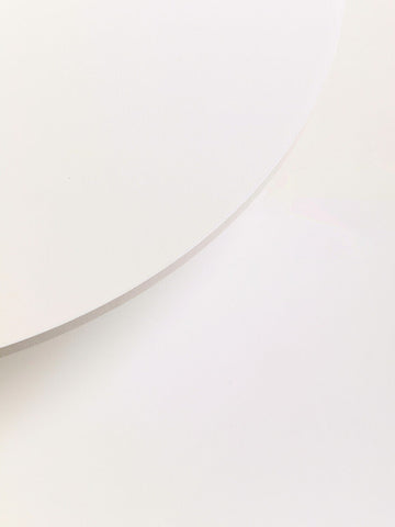 A minimalist two white round side table with a smooth matte finish perfect for modern living spaces