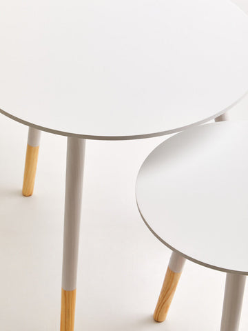 Viborg set of two white round side tables with slender white legs and natural wood tone accents at the bottom