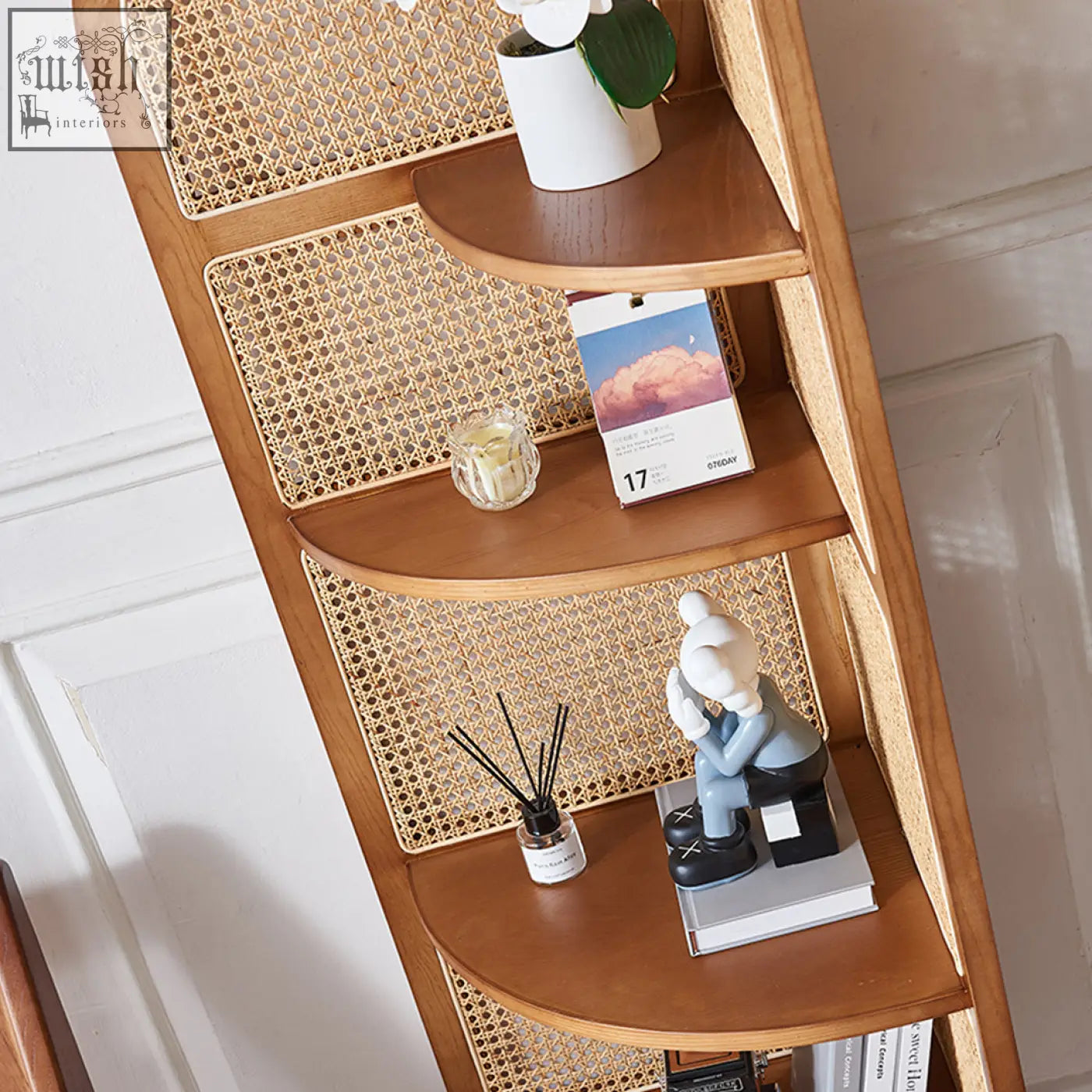 A vicente triangle bookshelf with curved wooden shelves and woven rattan panels for stylish storage