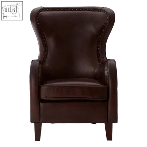 Dark brown leather victor lounge chair with high back button-tufted details and walnut wood legs