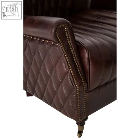 Victor brown leather winged back armchair with quilted diamond stitching curved arms and brass nailhead trim
