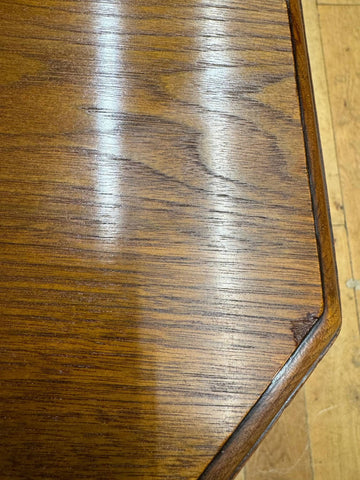 Polished dark brown victorian solid walnut table surface with smooth glossy finish and visible grain patterns