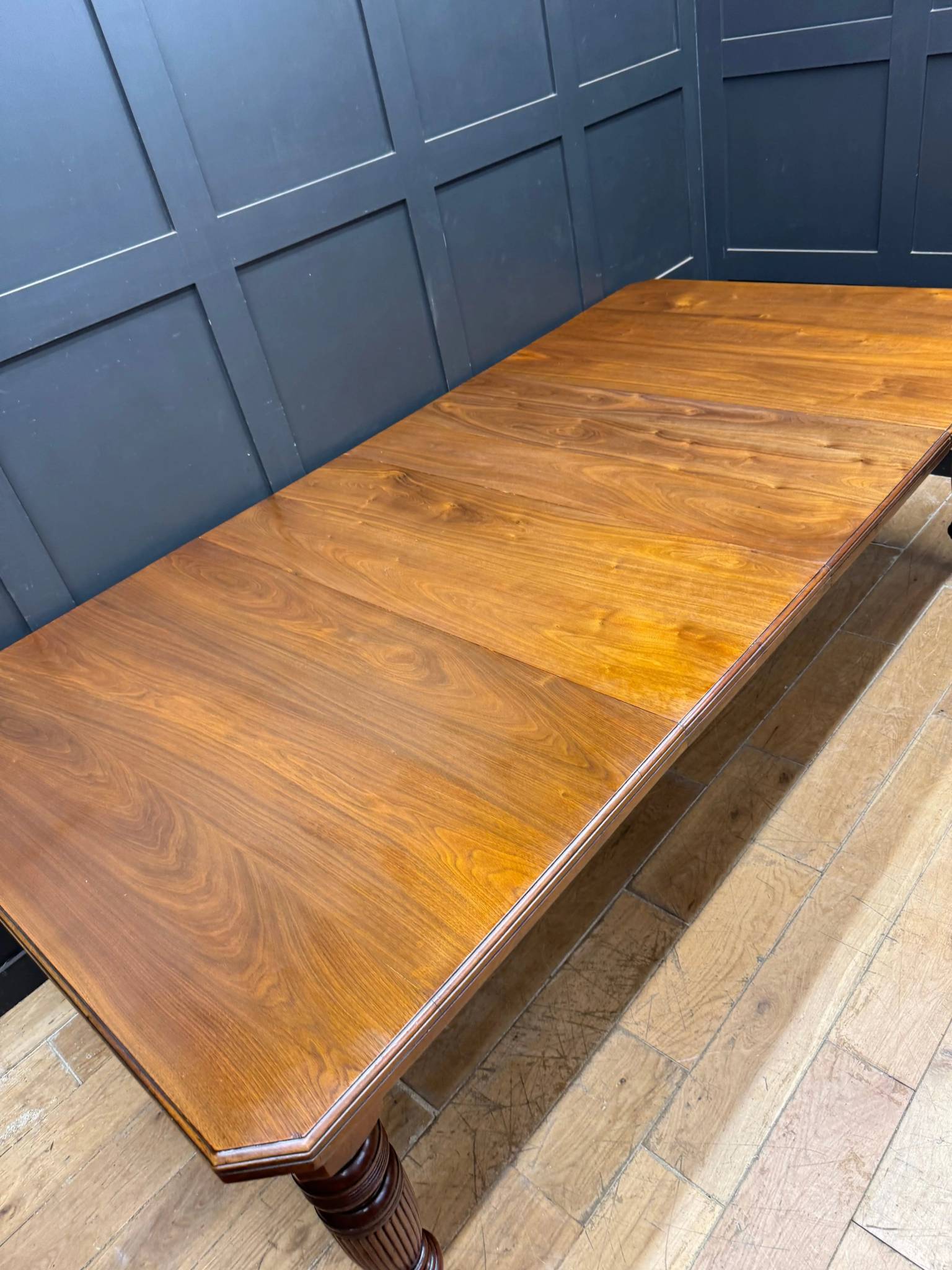 A victorian solid walnut extending dining table with warm tones and ornate legs seats 8 to 10 people comfortably