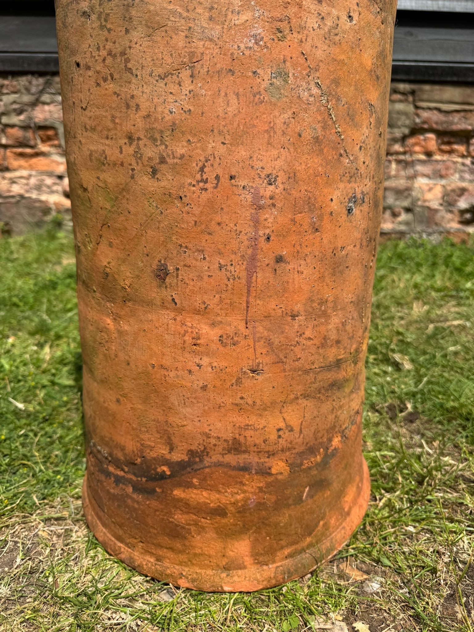 Rust-colored victorian terracotta chimney pot planter with weathered textured surface and antique charm