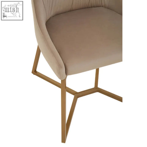 Beige mink velvet dining chair with a modern geometric gold metal frame perfect as a velvet dining chair