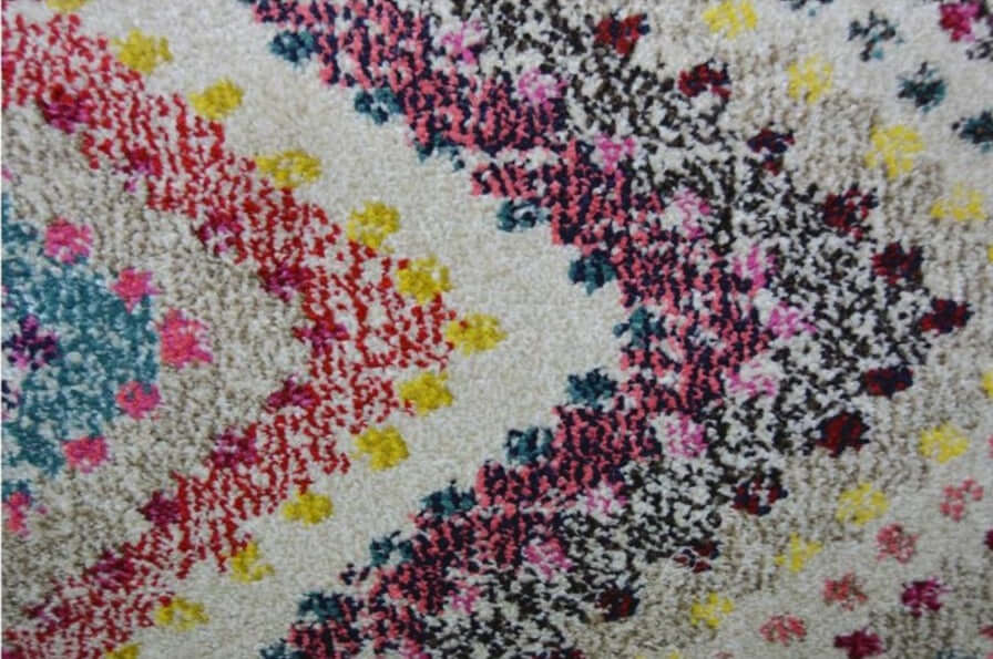 A plush villa multicolour diamond rug with vibrant scattered dots and abstract shapes on a beige background