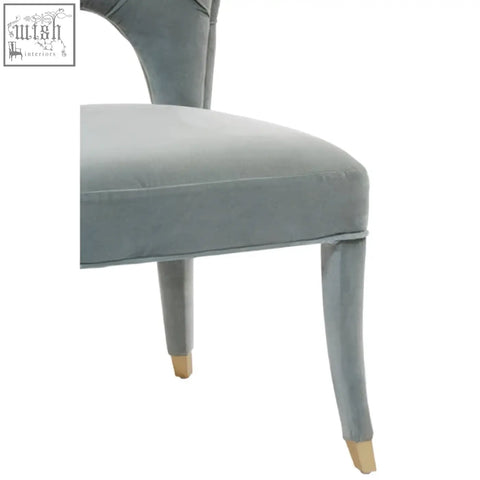Gray velvet tufted dining chair with gold-colored feet perfect for stylish velvet tufted dining spaces