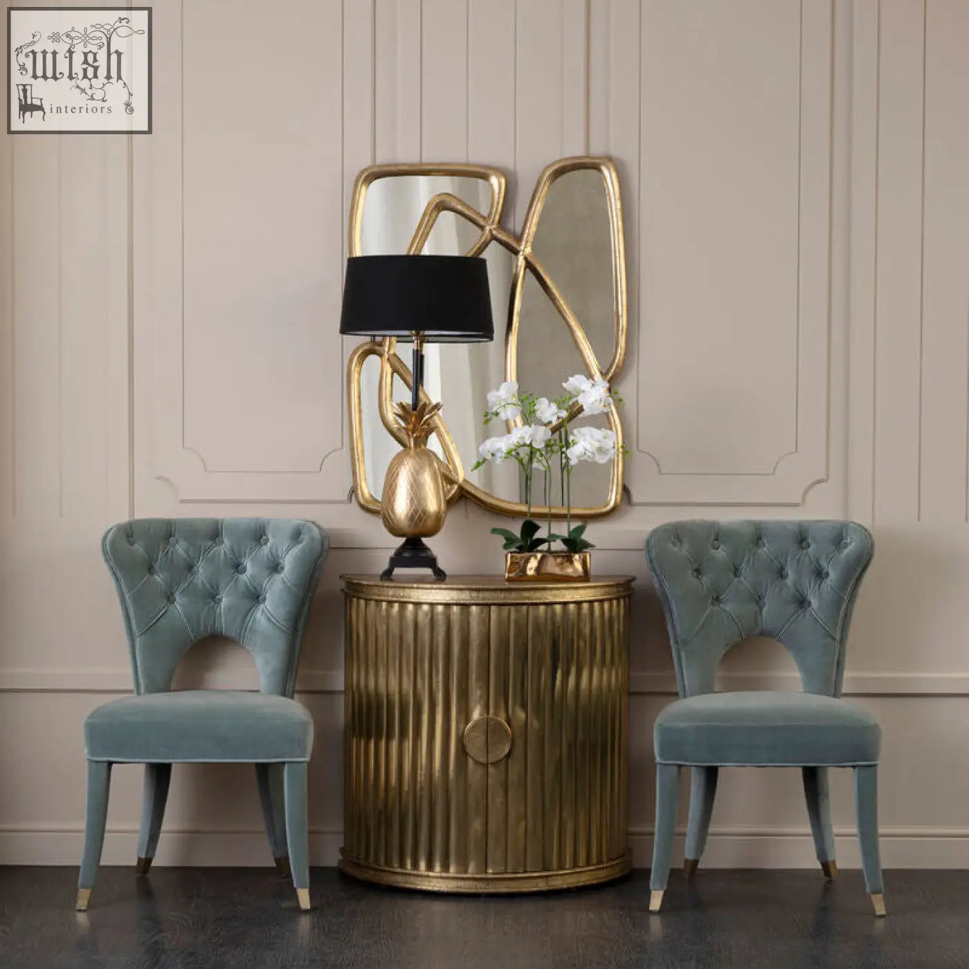 Gold pineapple table lamp with black shade next to blue velvet tufted dining chair for stylish dining decor
