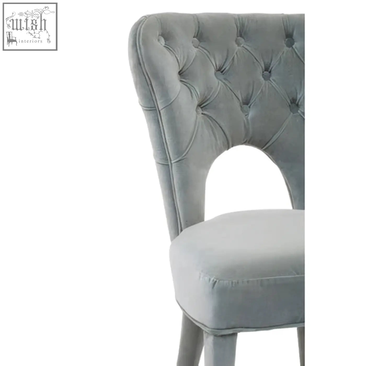 Light gray velvet tufted dining chair with curved back and oval cutout perfect for velvet tufted dining spaces