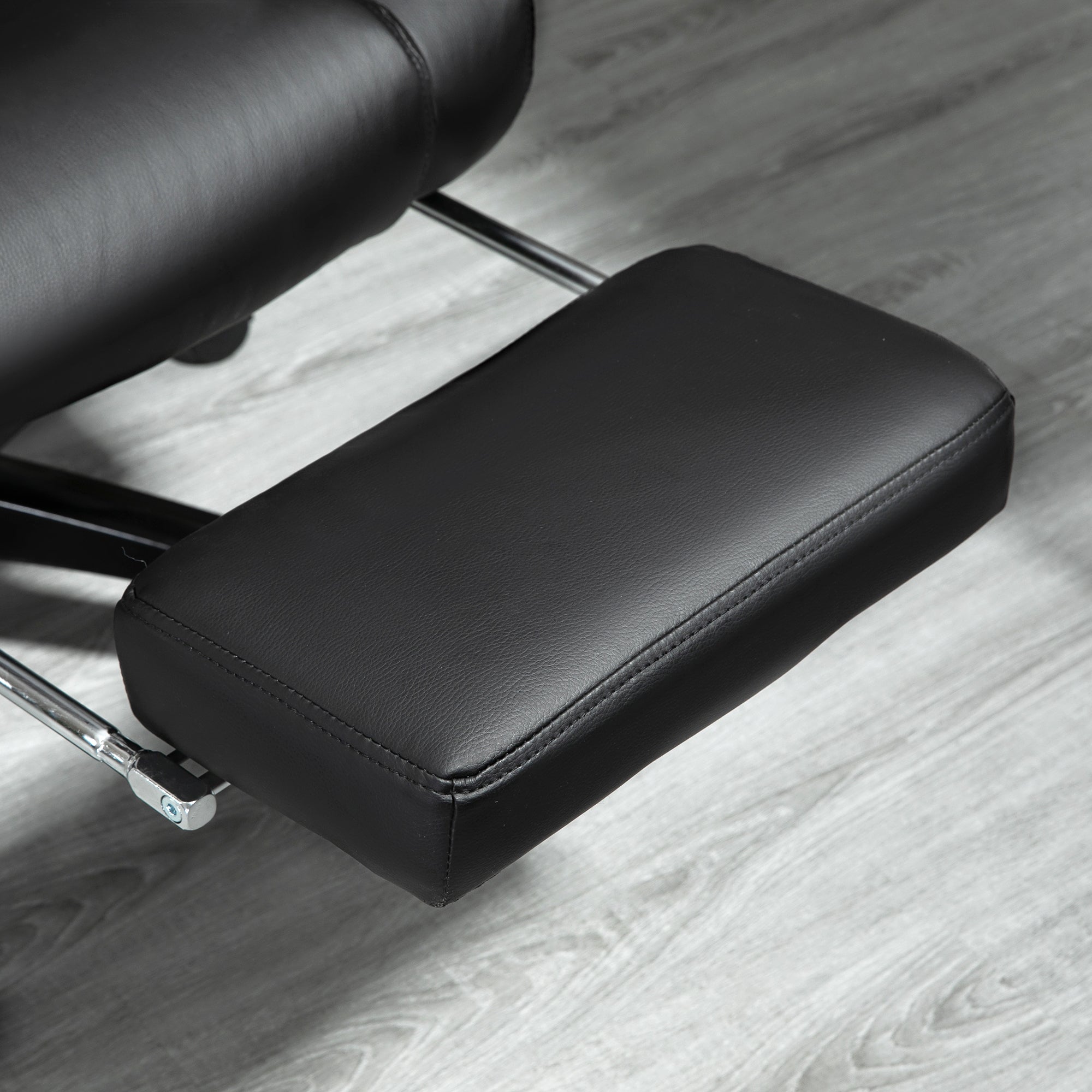 Black leatherette footrest pad with stitched edges on vinsetto office chair for extra comfort and sleek line design