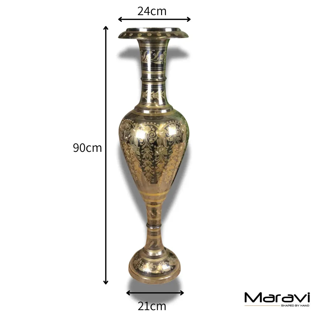 A large brass vase 90cm tall with intricate floral hand etchings and a silver and gold polished fluted rim