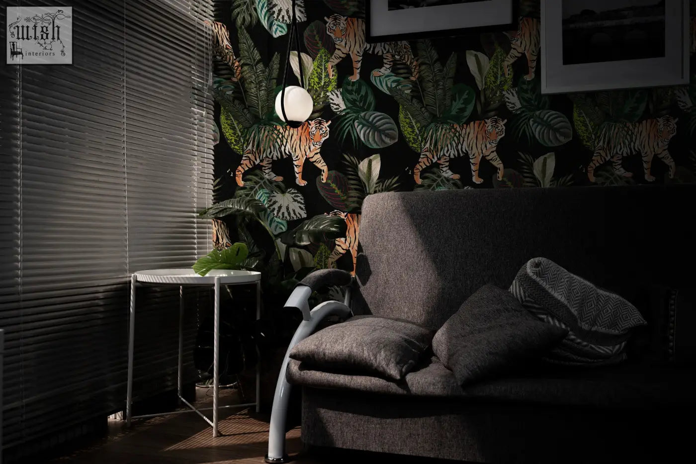 Dark gray upholstered sofa with textured fabric and cushions under vintage botanical wallpaper peel and stick dark tropical plants mural