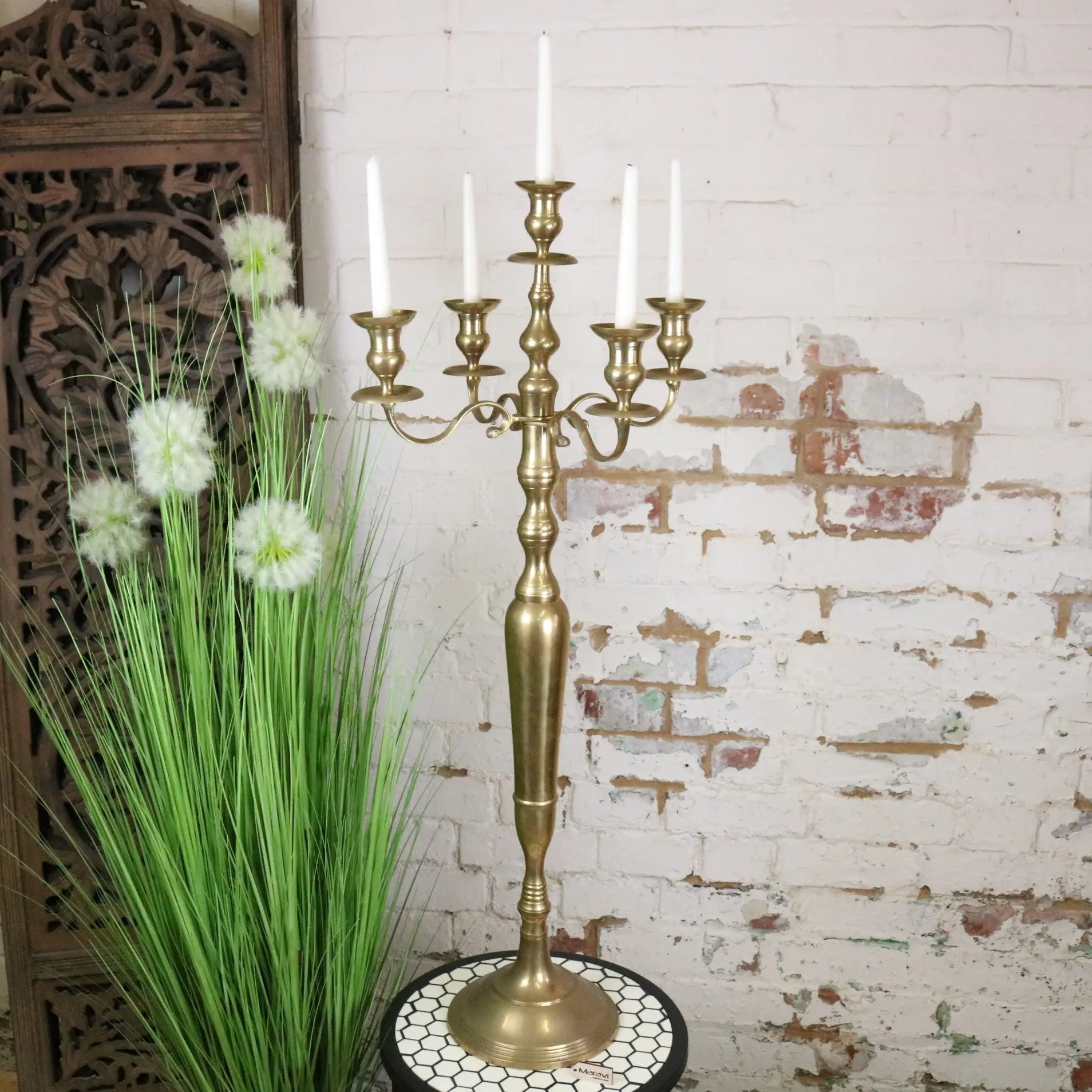 Vintage brass candelabra with five arms holding white candles in a classic 100cm brass candelabra design