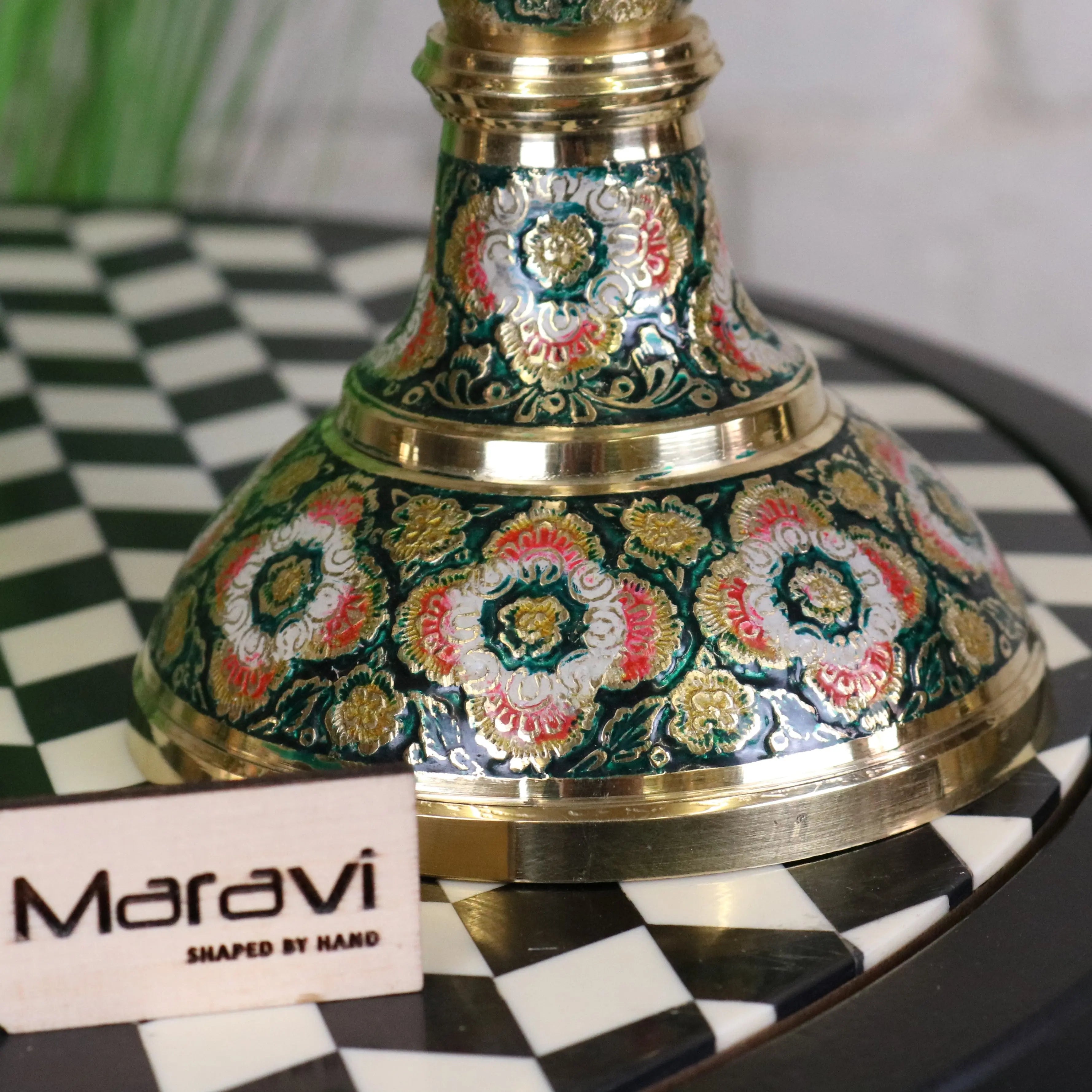 Vintage brass candlestick with intricate hand painted floral patterns in green pink white and gold