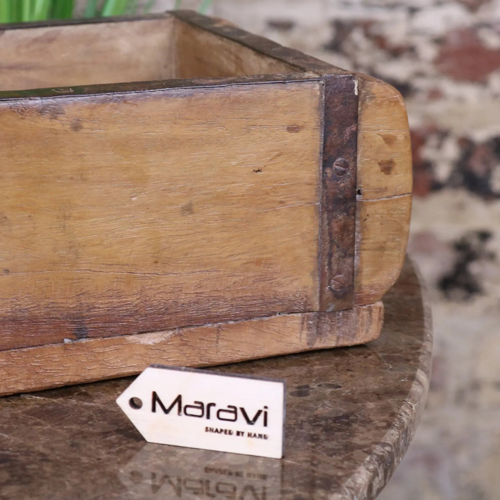 A vintage brick mould wooden rustic box with a hand-shaped design and dark metal reinforcements on edges