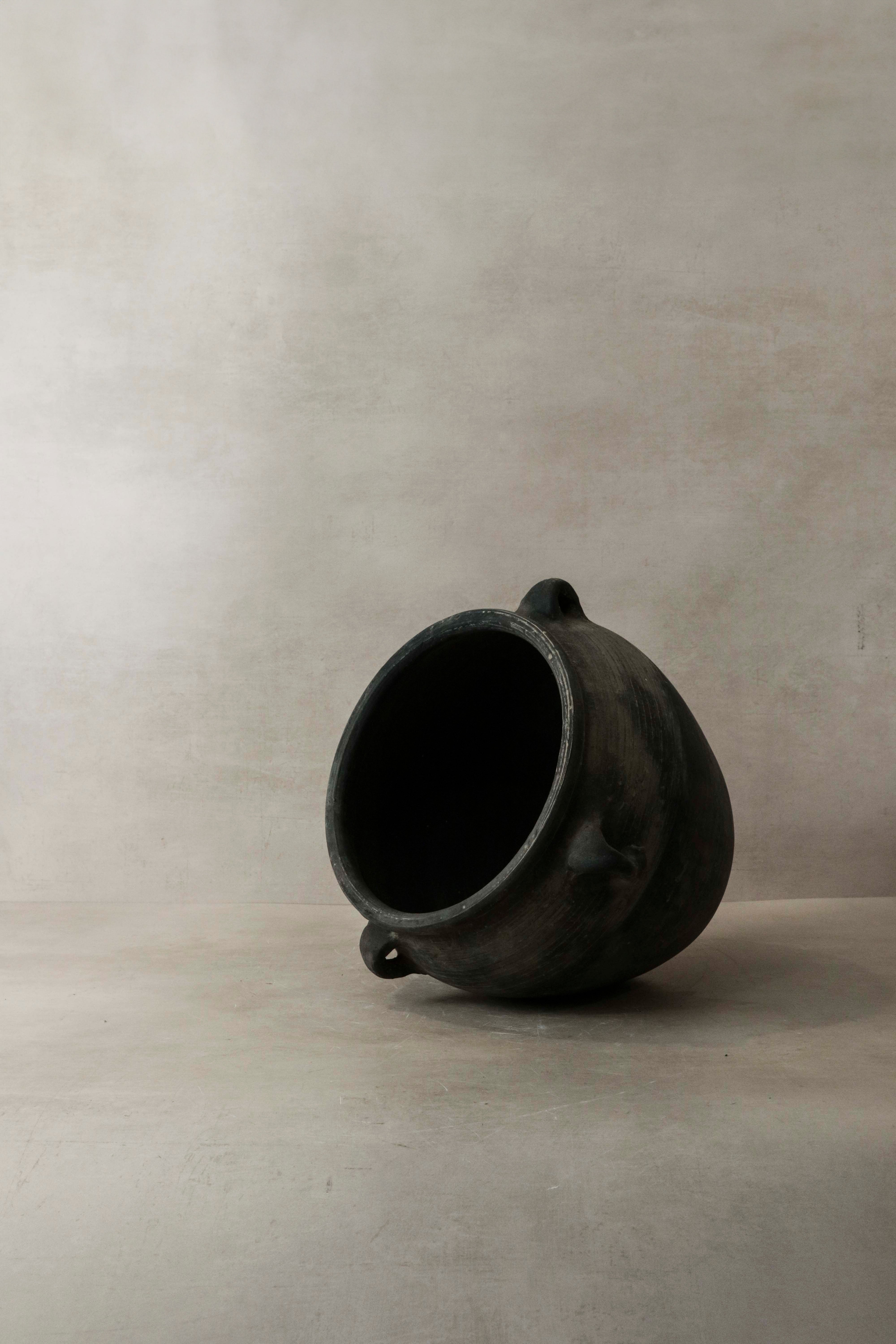 Dark gray vintage dark ceramic pot with two small looped handles perfect for rustic decor and storage