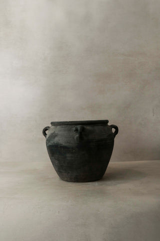 Vintage dark rustic ceramic jar with two looped handles on either side perfect for decor or storage