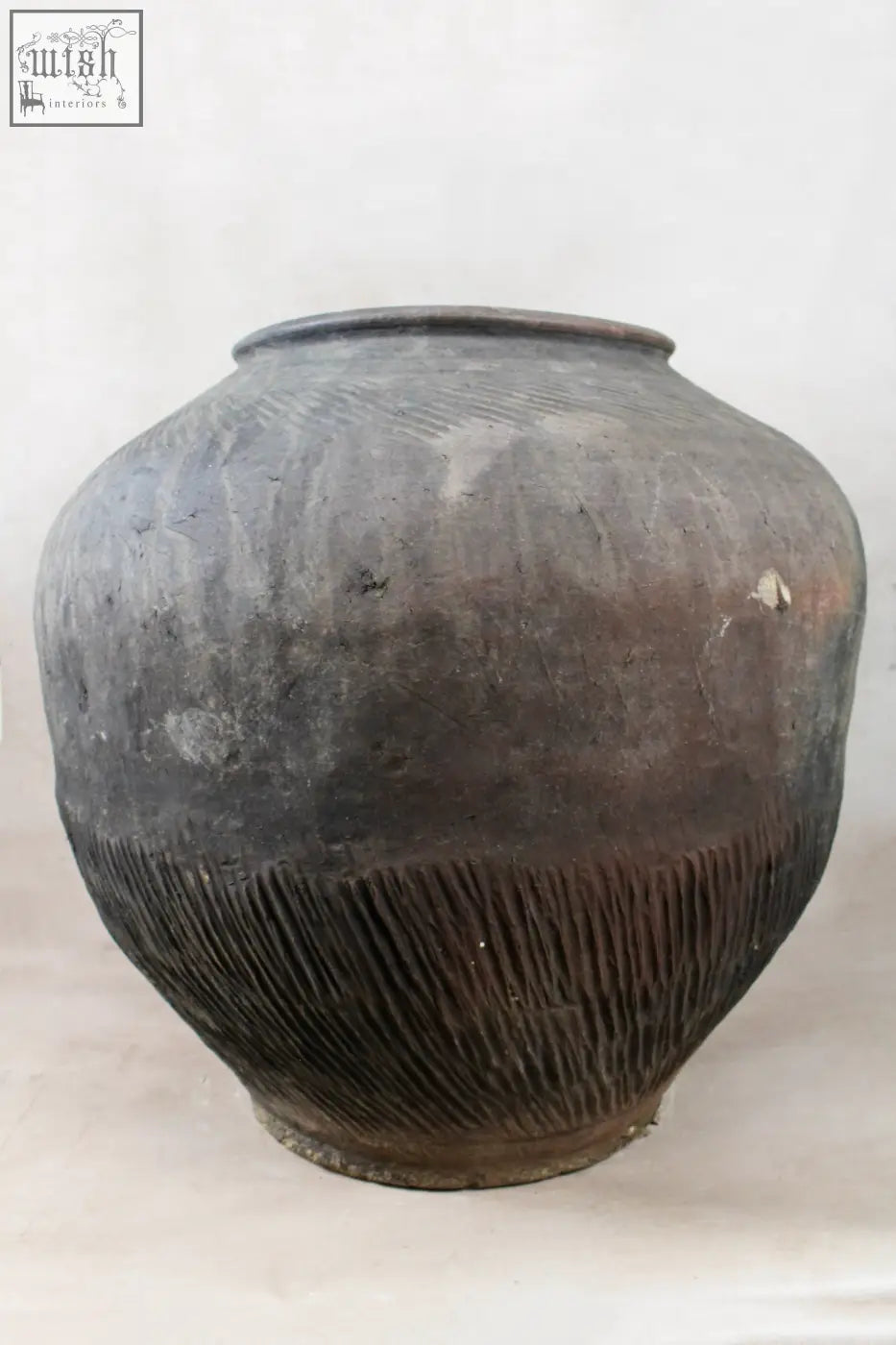 Vintage dark pot xl nº 7 with a weathered dark gray ceramic body and ribbed unglazed exterior from village potter
