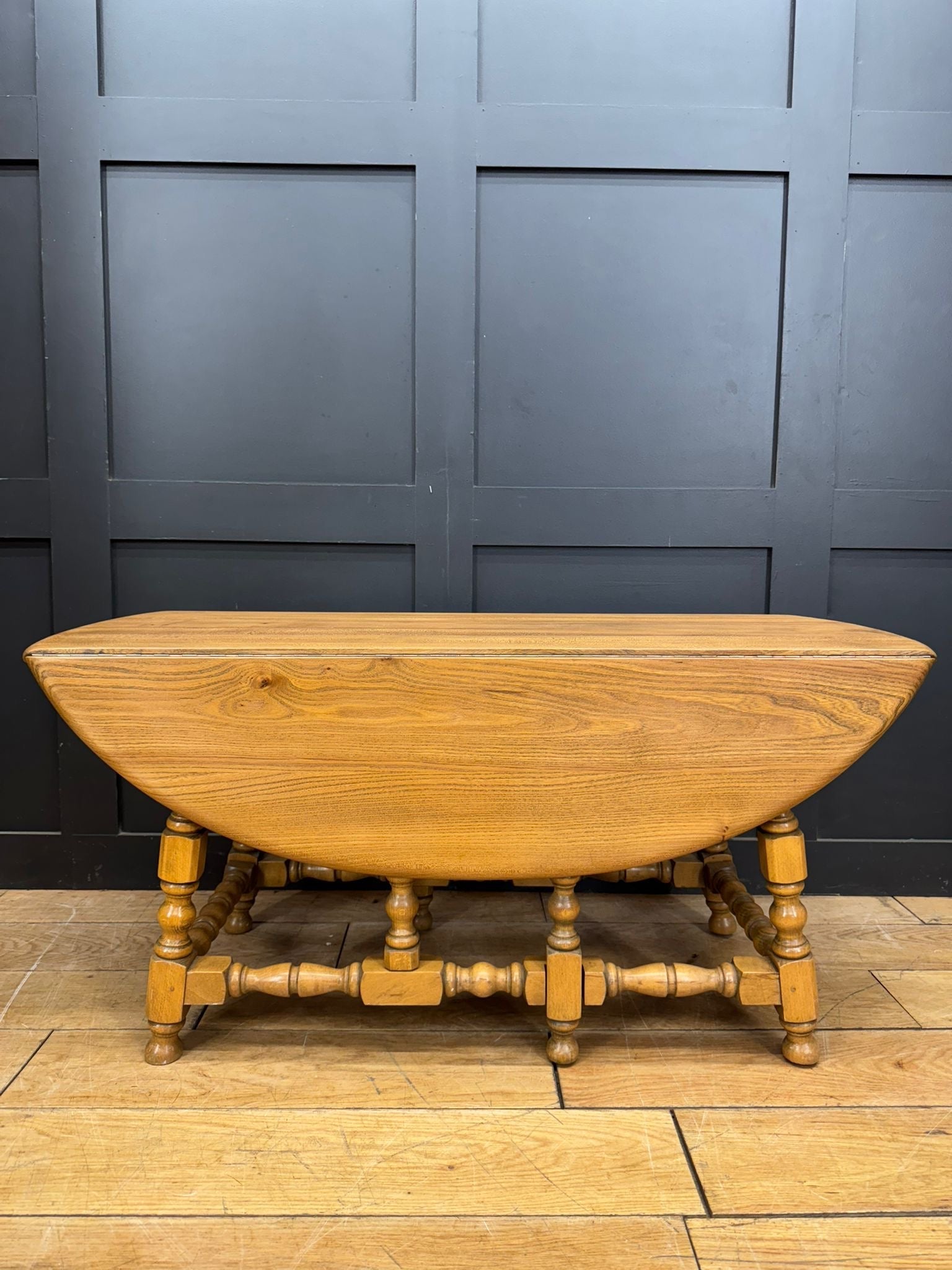 Vintage ercol model 506 light elm drop-leaf coffee table with turned legs and decorative stretcher base in tall windsor style