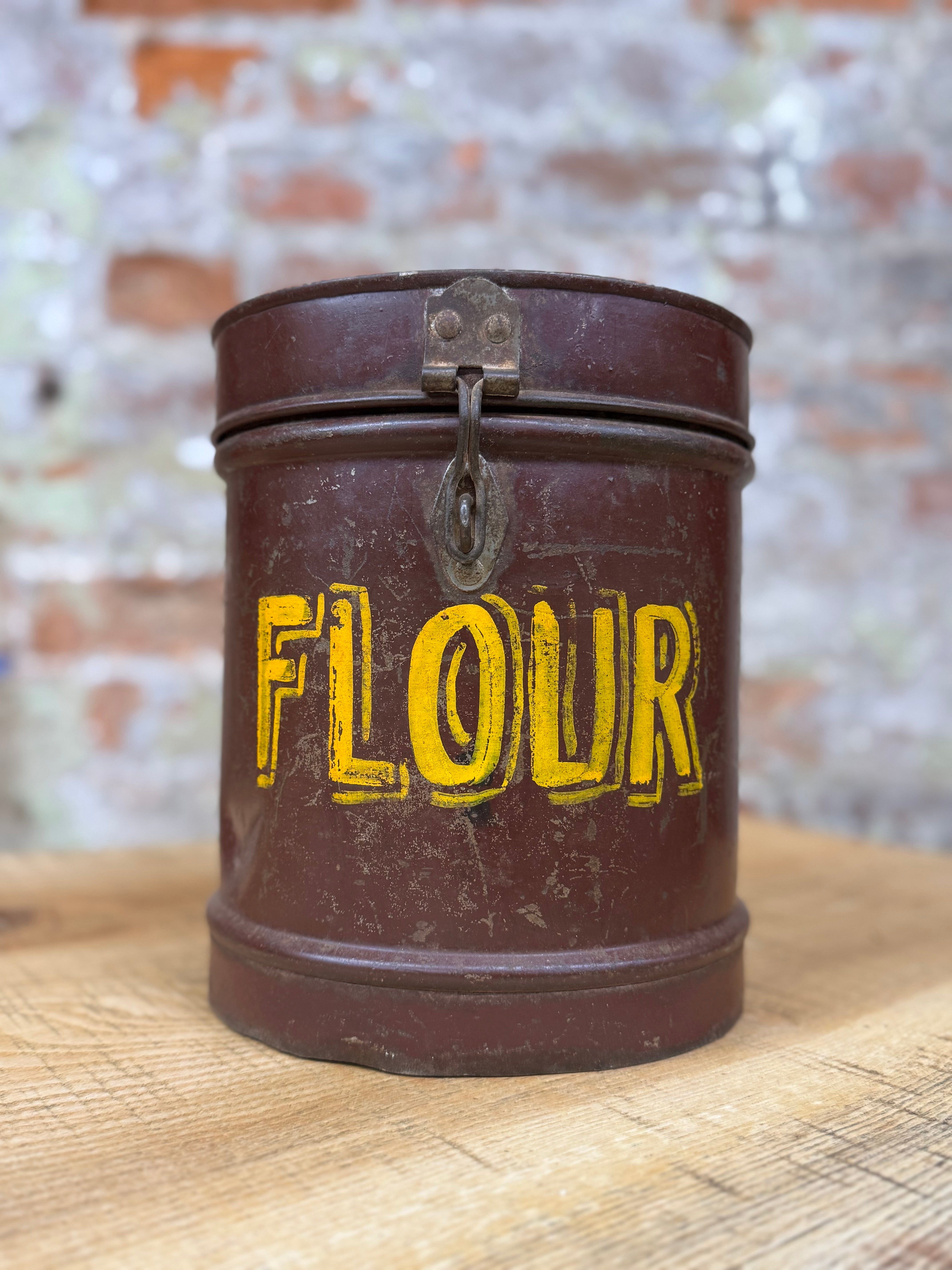 Vintage brown galvanised metal flour bin with yellow flour label and small latch on lid for kitchen storage