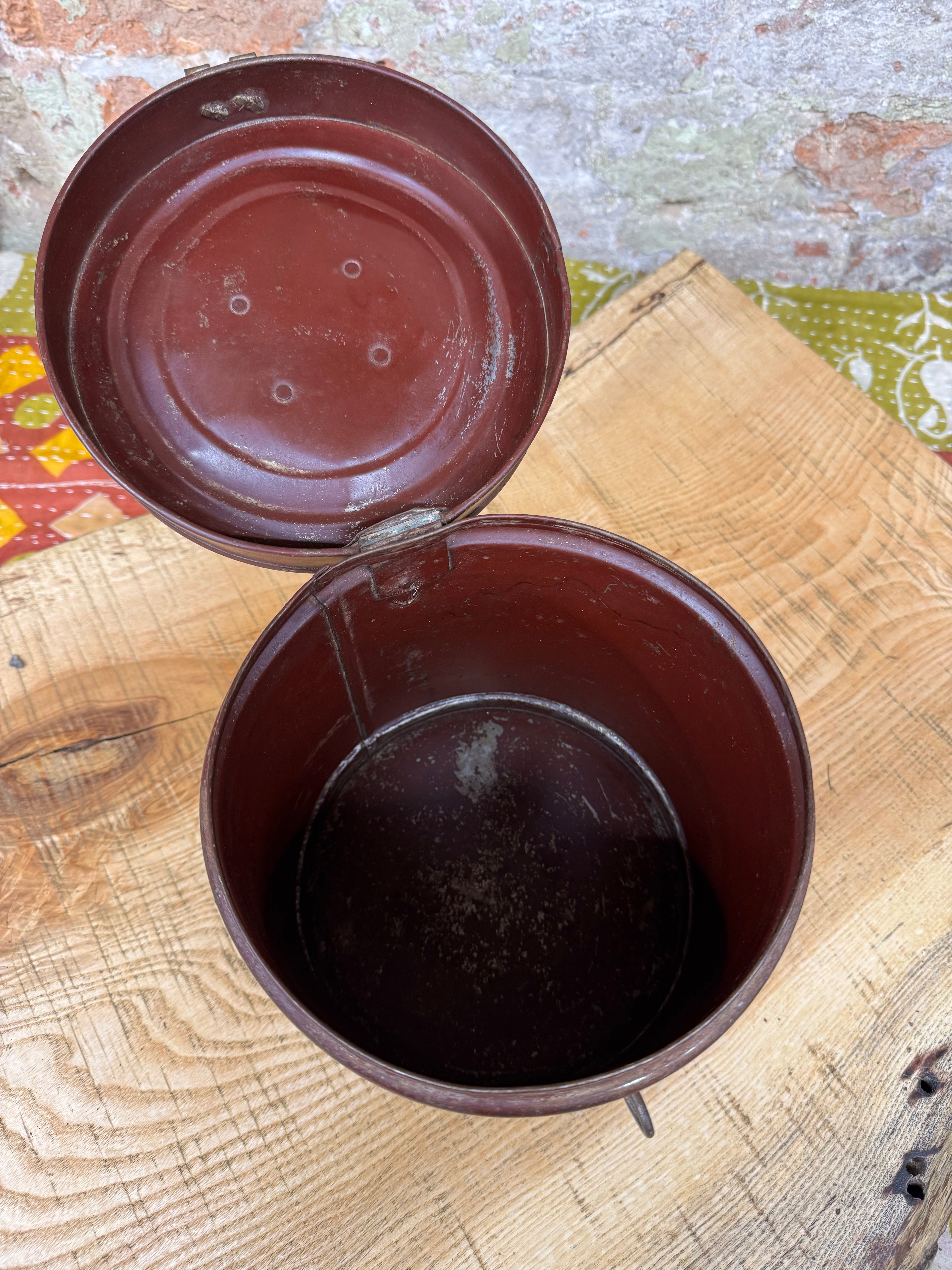 Vintage galvanised metal tub container in dark reddish brown with hinged lid and circular indentations inside the top