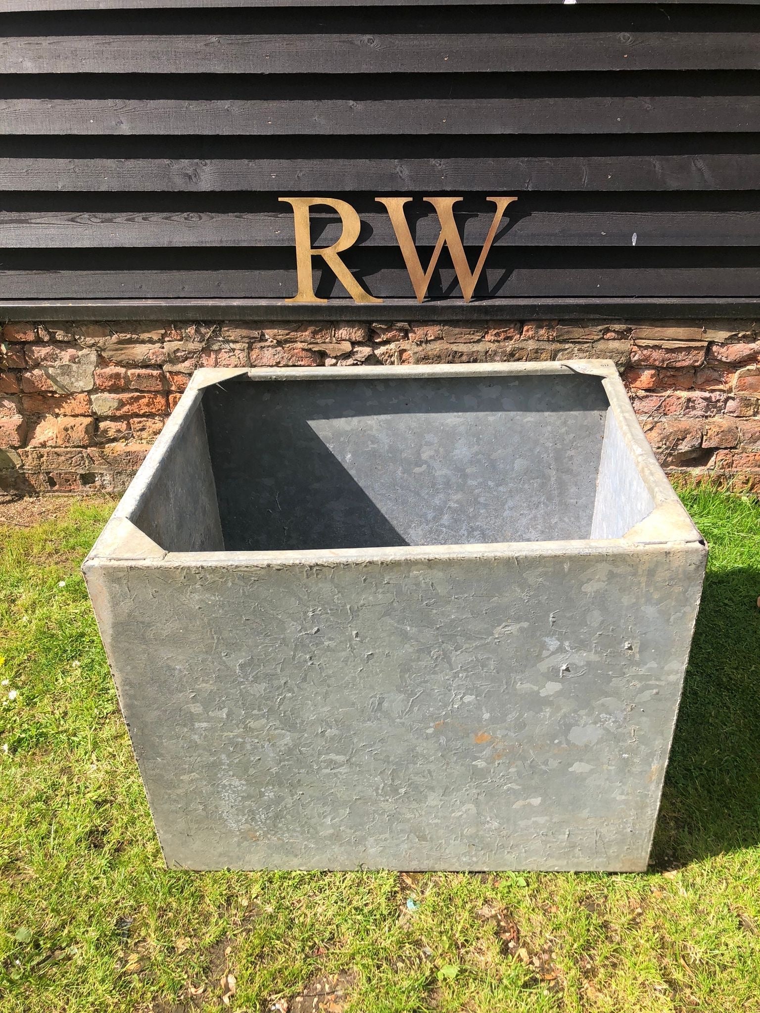 Vintage galvanized metal trough planter with weathered texture ideal for herb garden raised bed or plant pot use