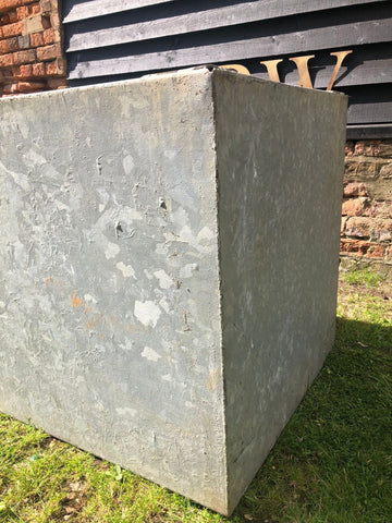 Vintage galvanised metal trough planter in weathered gray with rough texture ideal for herb garden or raised bed pond