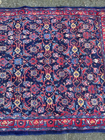 Vintage handmade wool rug arak sourak sarough with deep navy blue field and vibrant floral geometric patterns