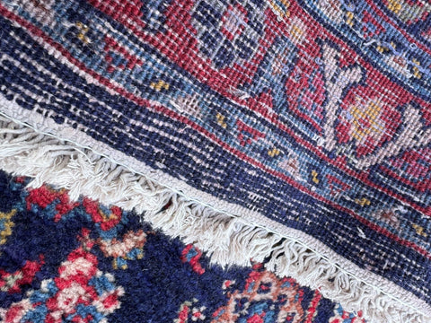 Vintage handmade wool rug with intricate navy burgundy floral geometric patterns and cream fringe 300cm x 133cm