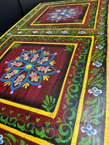 Vintage indian hand painted wooden coffee table with vibrant red floral and vine designs for living room use