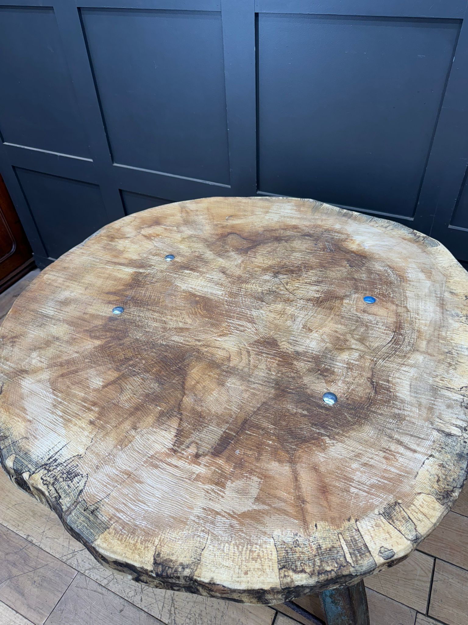 Vintage industrial kitchen dining table with rustic round maple top and cast iron base showing natural wood grain