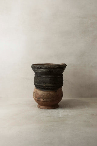 A rustic vintage nupe pot stand ceramic vessel with dark patterned top and lighter brown base perfect for display