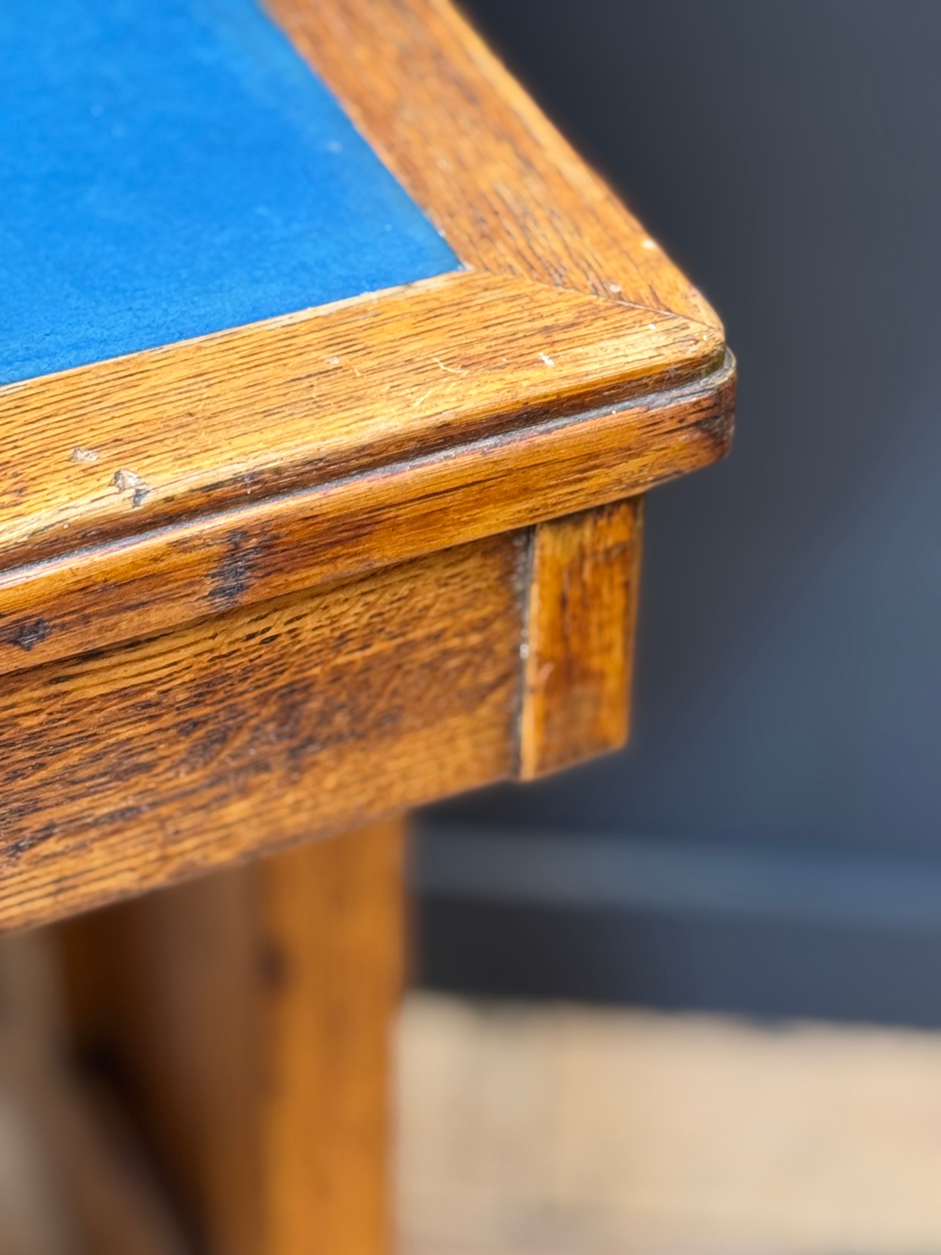 Vintage oak desk with warm grained wood frame and vibrant blue felt top perfect as a desk office or computer desk