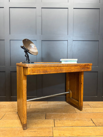 Vintage oak desk with sturdy metal support bar and a vintage-style lamp for desk office or computer use