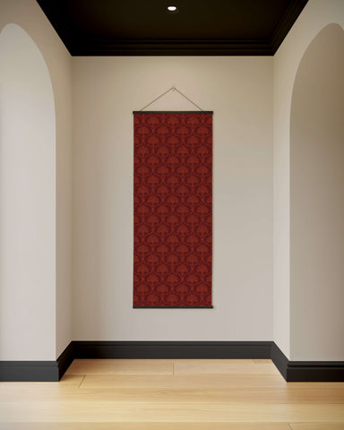 A rich burgundy vintage ornamental tapestry with intricate damask pattern framed by dark wooden trim hanging on a wall