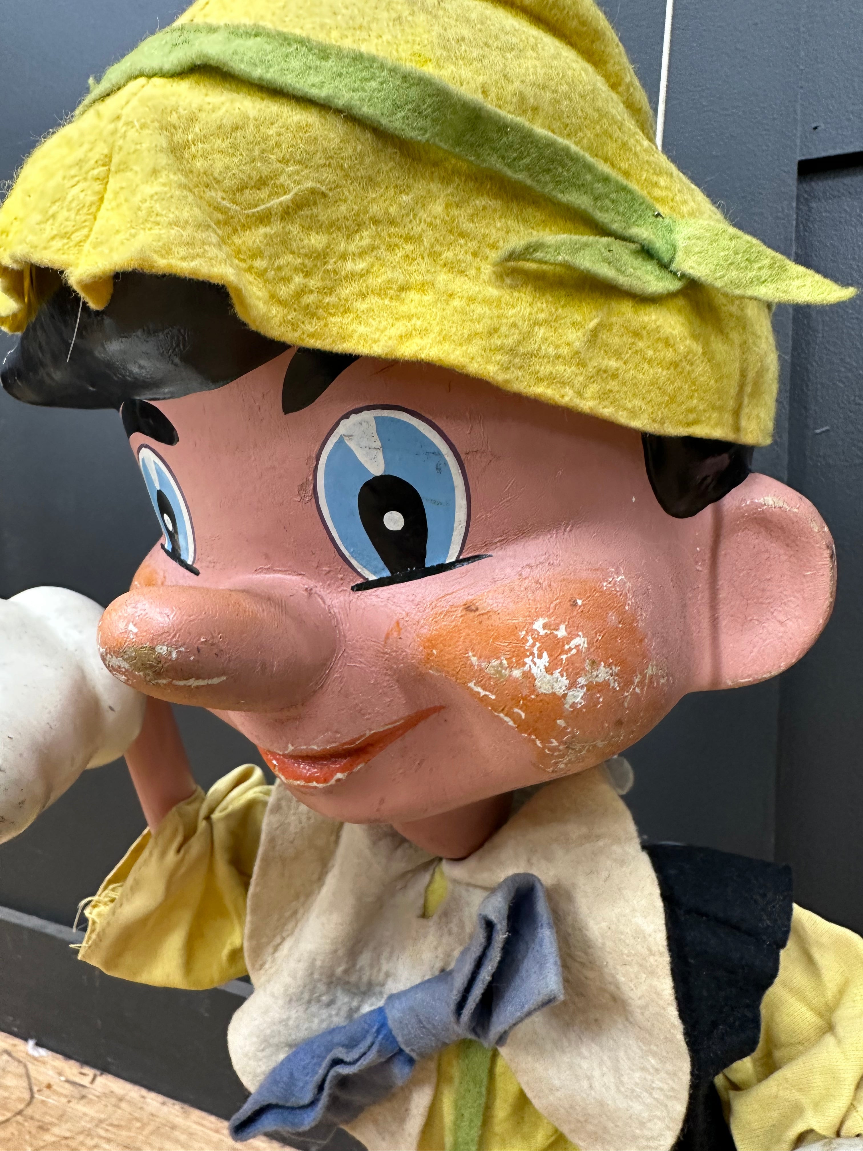 Vintage pelham puppets pinocchio puppet with yellow felt hat painted worn face and fabric clothes in yellow cream blue