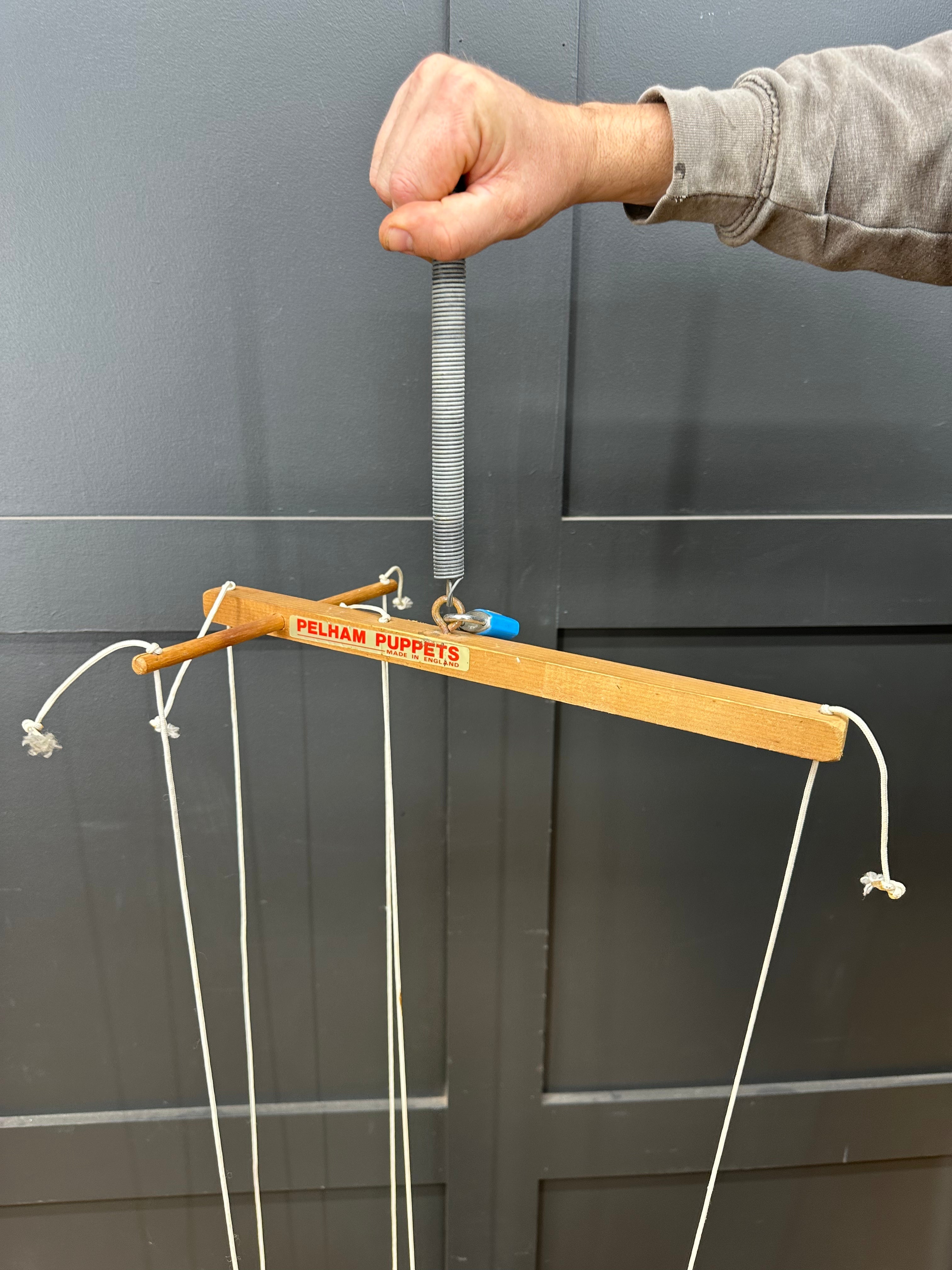 Wooden pelham puppets marionette control bar with spring-loaded handle and white strings for vintage puppet play