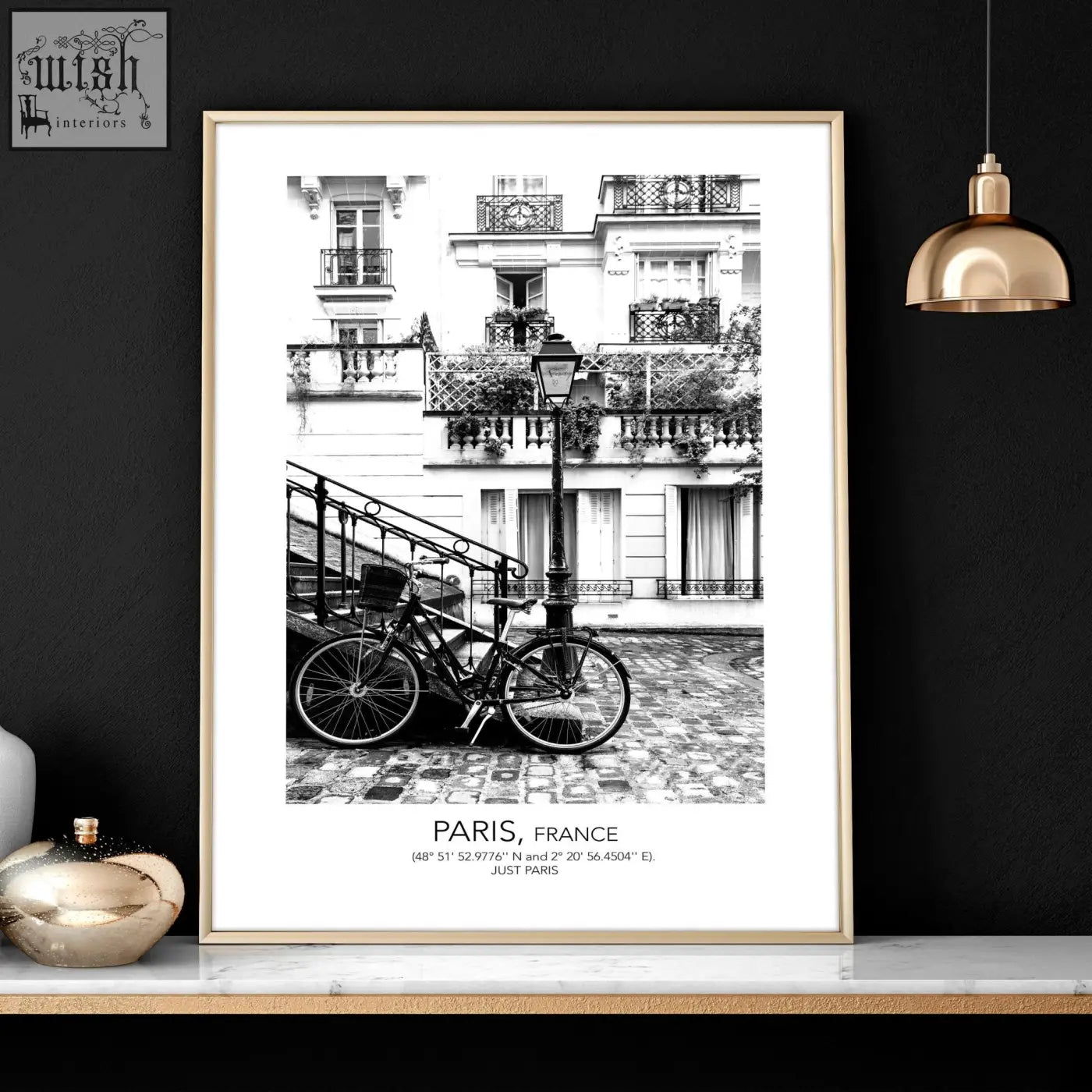 A framed black and white parisian street scene with a bicycle and paris france text in vintage wall art prints set