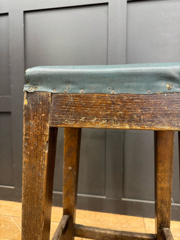 Vintage railway stool with teal leather seat brass nailhead trim and wooden frame inspired by lner train station seating