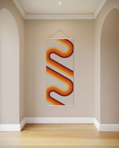 A vintage retro wall hanging tapestry with bold orange and red wavy retro lines on a cream background