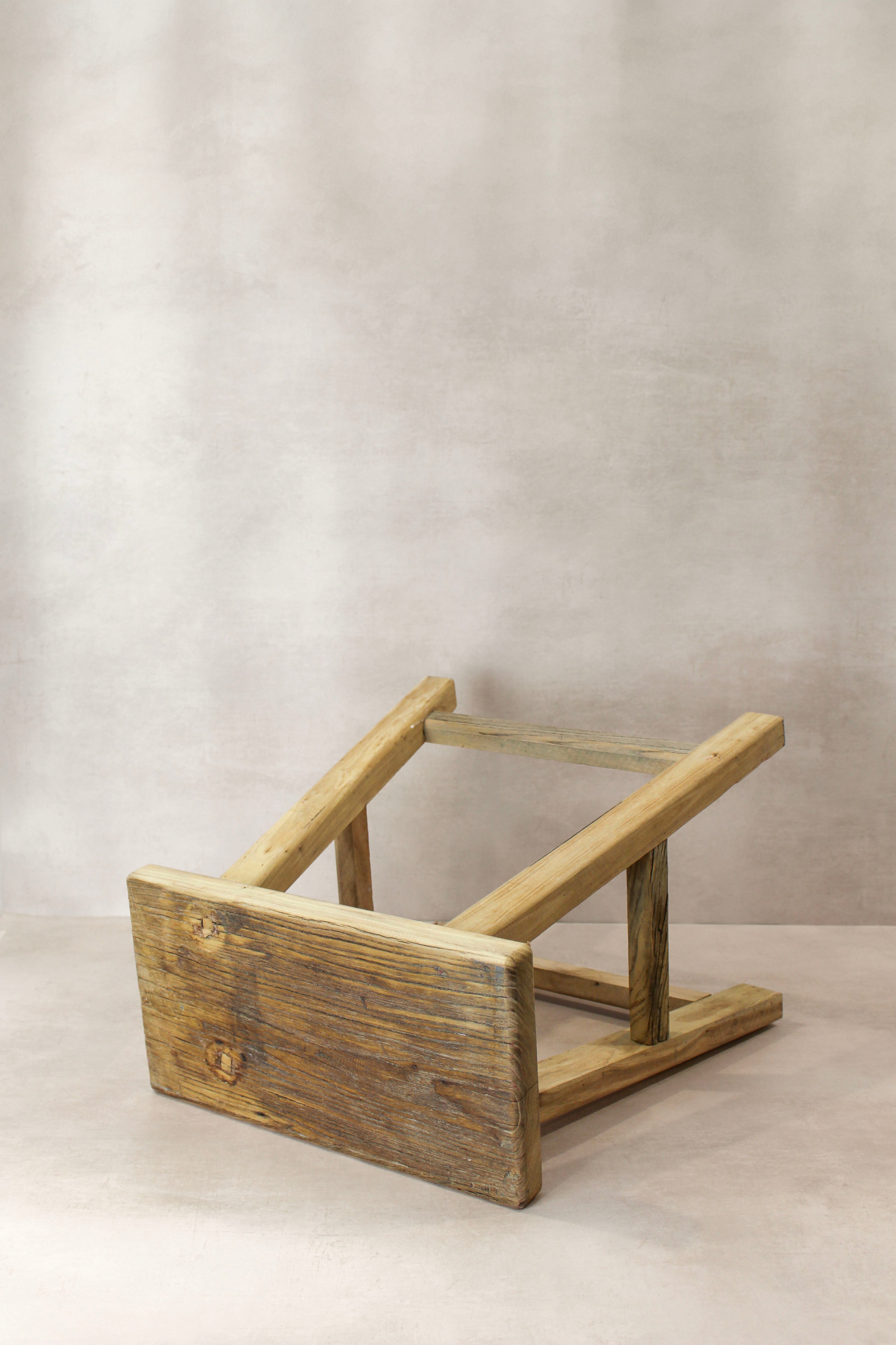 Vintage rustic elm wood stool with a weathered finish and simple sturdy construction in medium size