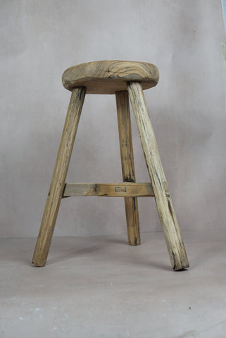 Vintage rustic elm wood stool with round weathered seat and four sturdy legs perfect for cozy spaces