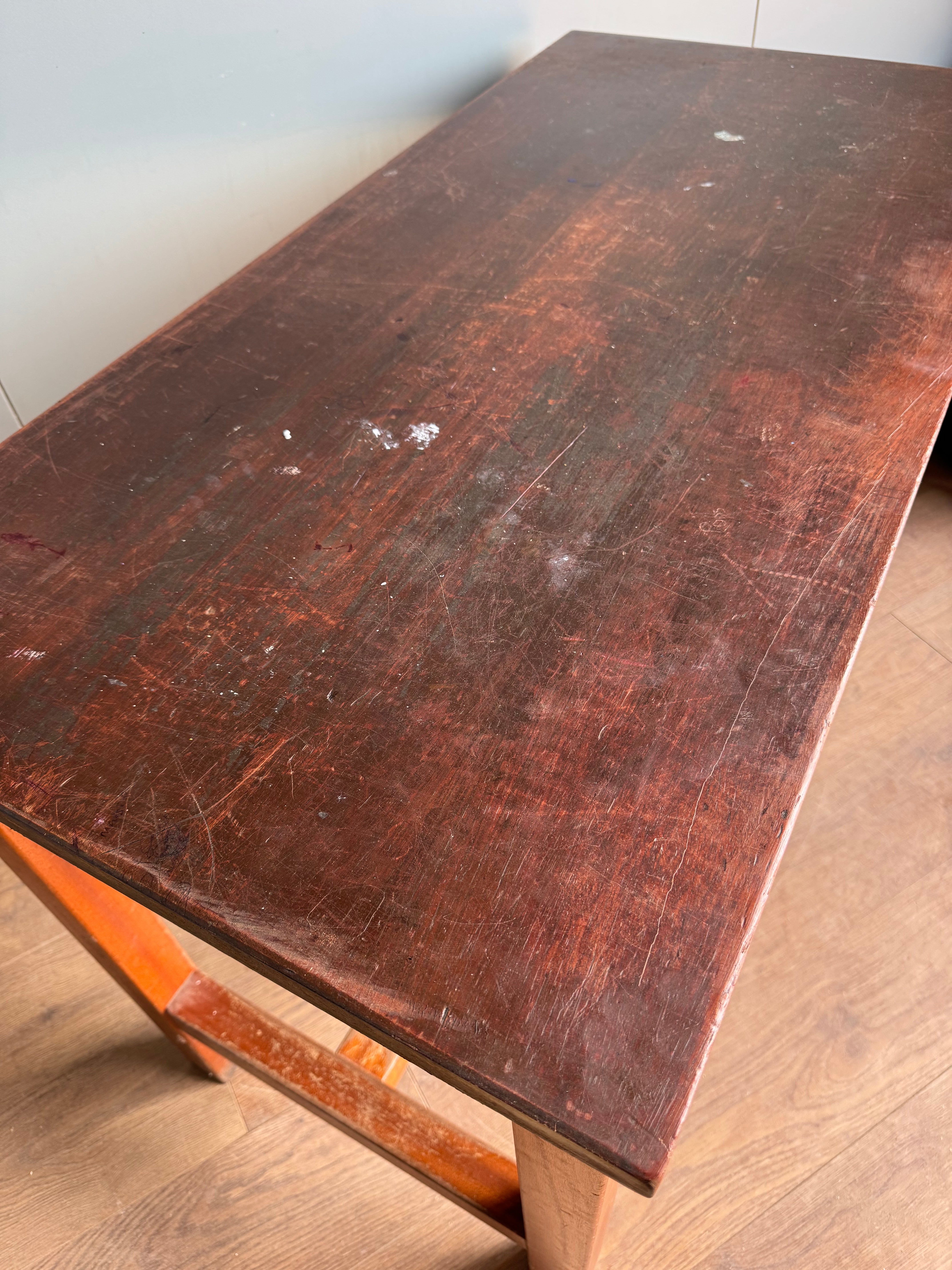 Worn dark brown iroko top on vintage school lab bench with beech frame shows scratches and scuffs for science lab use