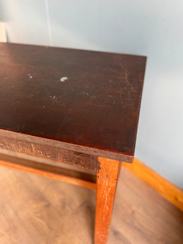Vintage school lab bench with dark brown iroko top and worn finish on orange beech frame legs for science lab use