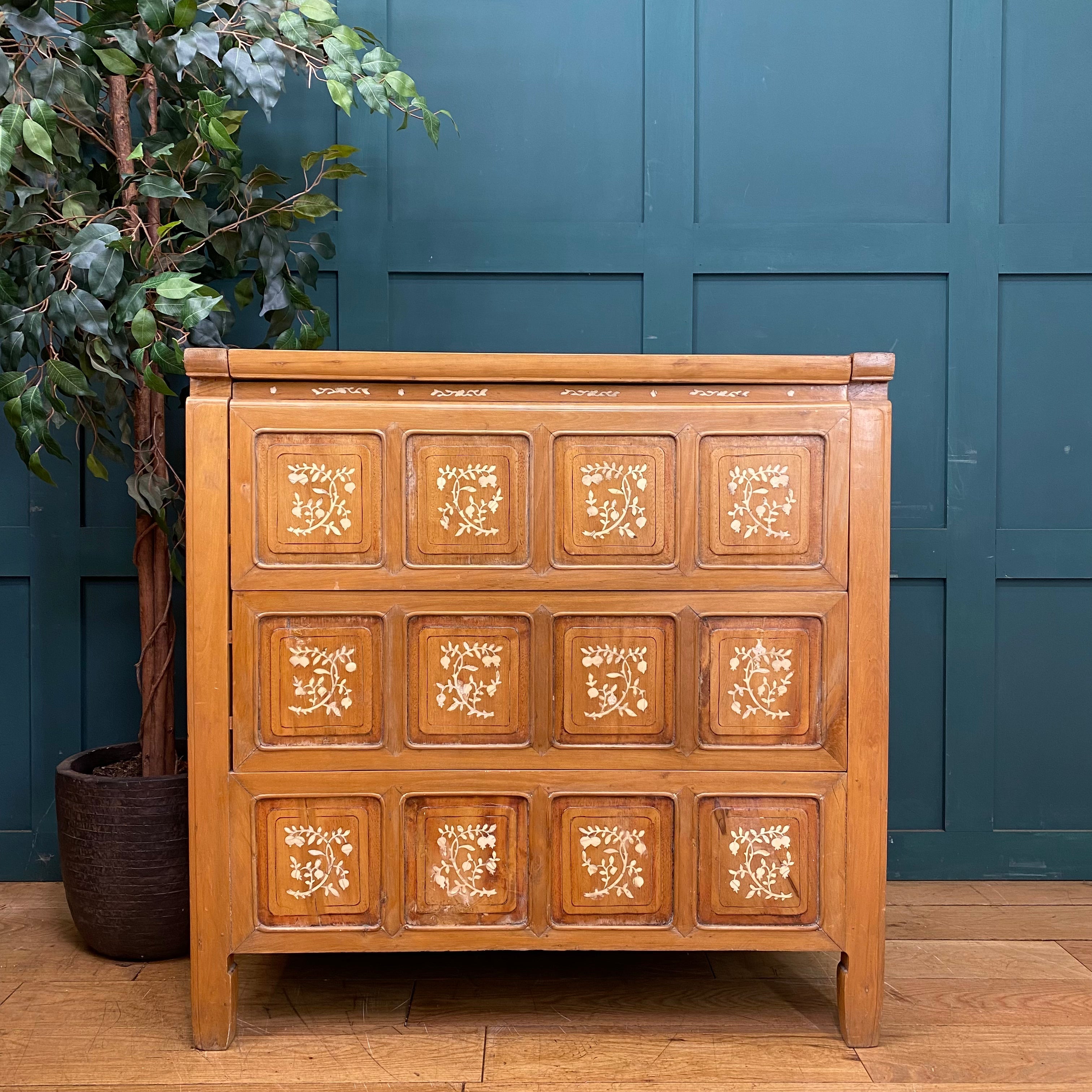 Vintage warm-toned wooden dowry chest with nine square panels and delicate white floral inlay patterns